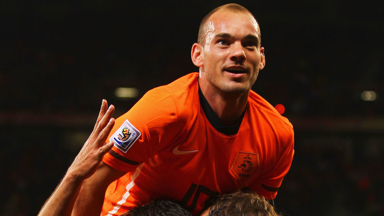 CAPE TOWN, SOUTH AFRICA - JULY 06: Wesley Sneijder of the Netherlands (top) celebrates with goalscorer Giovanni Van Bronckhorst (C) after he scores the opening goal with team mate Joris Mathijsen during the 2010 FIFA World Cup South Africa Semi Final match between Uruguay and the Netherlands at Green Point Stadium on July 6, 2010 in Cape Town, South Africa.