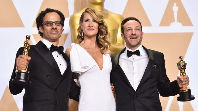 HOLLYWOOD, CA - MARCH 04: Actor Laura Dern (C) with producer Dan Cogan (L) and director Bryan Fogel, winners of the Best Documentary Feature for Icarus pose in the press room during the 90th Annual Academy Awards at Hollywood & Highland Center on March 4, 2018 in Hollywood, California.
