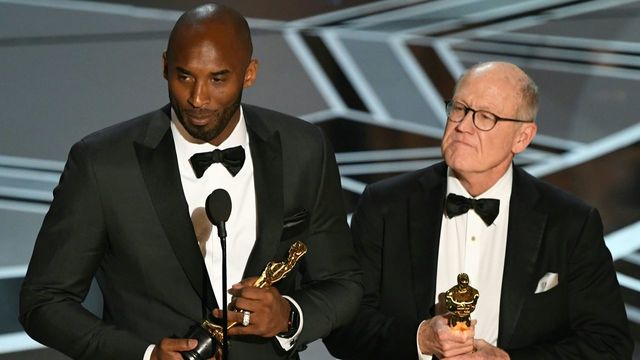 US basketball player Kobe Bryant (L) and US director Glen Keane stand on stage after they won the Best Animated Short Film for 'Dear Basketball' during the 90th Annual Academy Awards show on March 4, 2018 in Hollywood, California. / AFP PHOTO / Mark Ralston