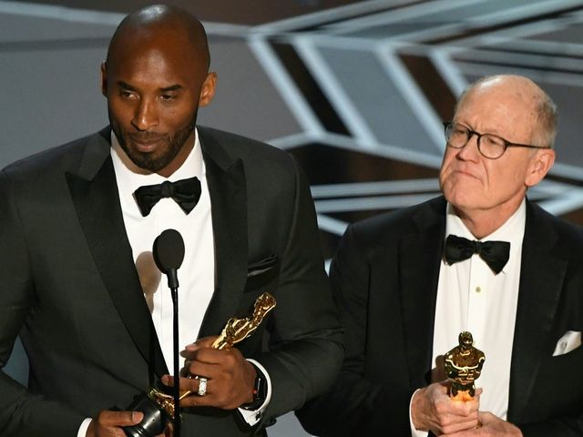 US basketball player Kobe Bryant (L) and US director Glen Keane stand on stage after they won the Best Animated Short Film for 'Dear Basketball' during the 90th Annual Academy Awards show on March 4, 2018 in Hollywood, California. / AFP PHOTO / Mark Ralston