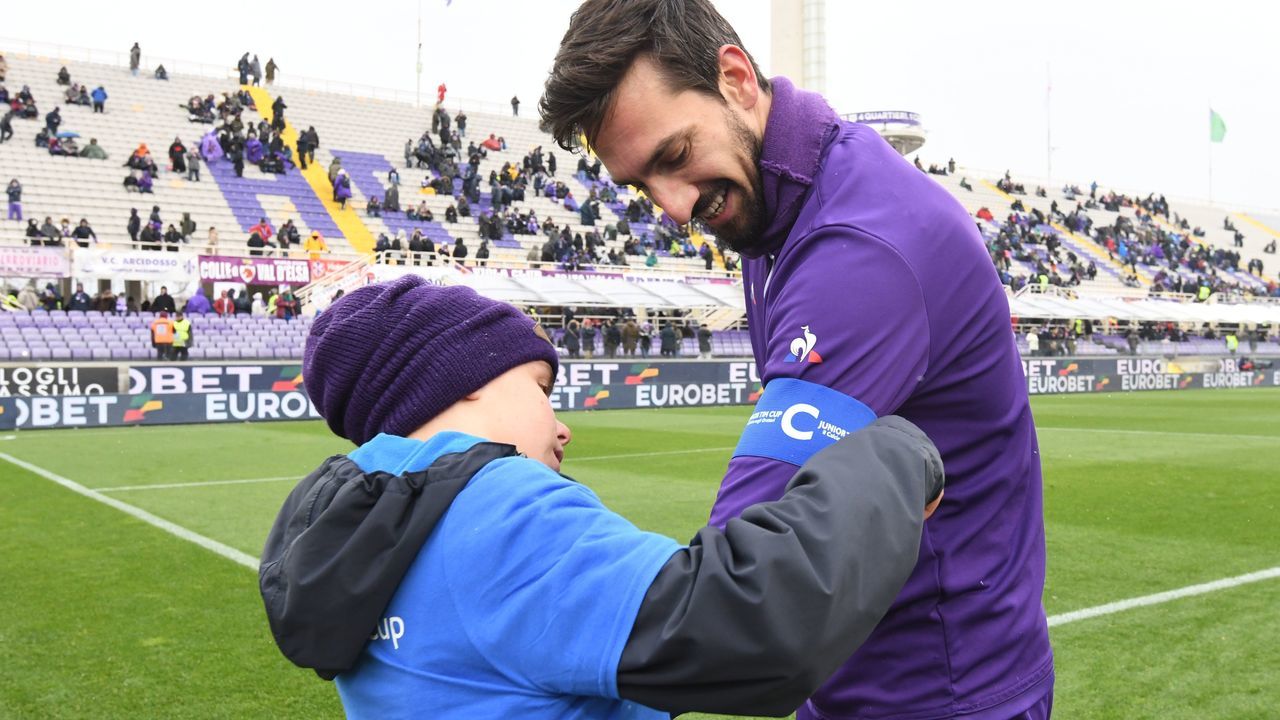A boy gives the captain's armband to Fiorentina's player Davide Astori on February 25, 2018 before the Italian Seria A football match Fiorentina vs Chievo, in Florence. Italy international defender Davide Astori was found dead in his hotel room on March 4, 2018 in Udine, where he was due to play a Serie A game between Udinese and Fiorentina. / AFP PHOTO / Claudio GIOVANNINI