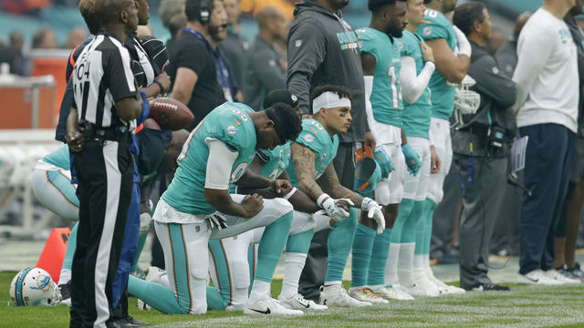 LONDON, ENGLAND - OCTOBER 01: Miami Dolphins players kneel down during the national anthem before the NFL game between the Miami Dolphins and the New Orleans Saints at Wembley Stadium on October 1, 2017 in London, England.