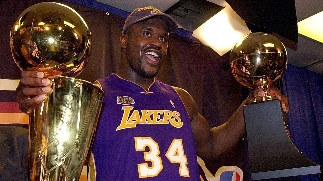 PHILADELPHIA, UNITED STATES: Shaquille O'Neal holds the MVP trophy (R) and the Larry O'Brian Championship trophy (L) after the Los Angeles Lakers won game five of the NBA Finals against the Philadelphia 76ers 15 June, 2001 at First Union Center in Philadelphia, PA. The Lakers won the game 108-96 to win the best-of-seven game series 4-1. AFP PHOTO Stan HONDA