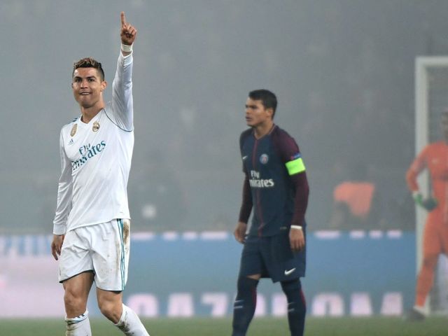 Real Madrid's Portuguese forward Cristiano Ronaldo celebrates after scoring the opening goal during the UEFA Champions League round of 16 second leg football match between Paris Saint-Germain (PSG) and Real Madrid on March 6, 2018, at the Parc des Princes stadium in Paris. / AFP PHOTO / CHRISTOPHE SIMON