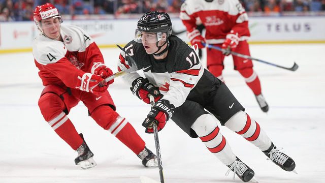 BUFFALO, NY - DECEMBER 30: Tyler Steenbergen #17 of Canada skates the puck past Christian Larsen #4 of Denmark during the third period of play in the IIHF World Junior Championships at the KeyBank Center on December 30, 2017 in Buffalo, New York.