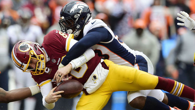 LANDOVER, MD - DECEMBER 24: Quarterback Kirk Cousins #8 of the Washington Redskins is sacked by outside linebacker Von Miller #58 of the Denver Broncos in the second quarter at FedExField on December 24, 2017 in Landover, Maryland.