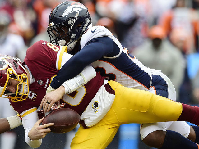 LANDOVER, MD - DECEMBER 24: Quarterback Kirk Cousins #8 of the Washington Redskins is sacked by outside linebacker Von Miller #58 of the Denver Broncos in the second quarter at FedExField on December 24, 2017 in Landover, Maryland.