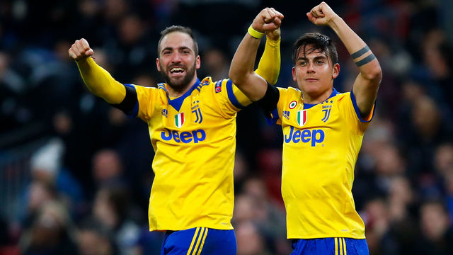 LONDON, ENGLAND - MARCH 07: Paulo Dybala (R) of Juventus celebrates with his team mate Gonzalo Higuain after scoring his team's second goal during the UEFA Champions League Round of 16 Second Leg match between Tottenham Hotspur and Juventus at Wembley Stadium on March 7, 2018 in London, United Kingdom.