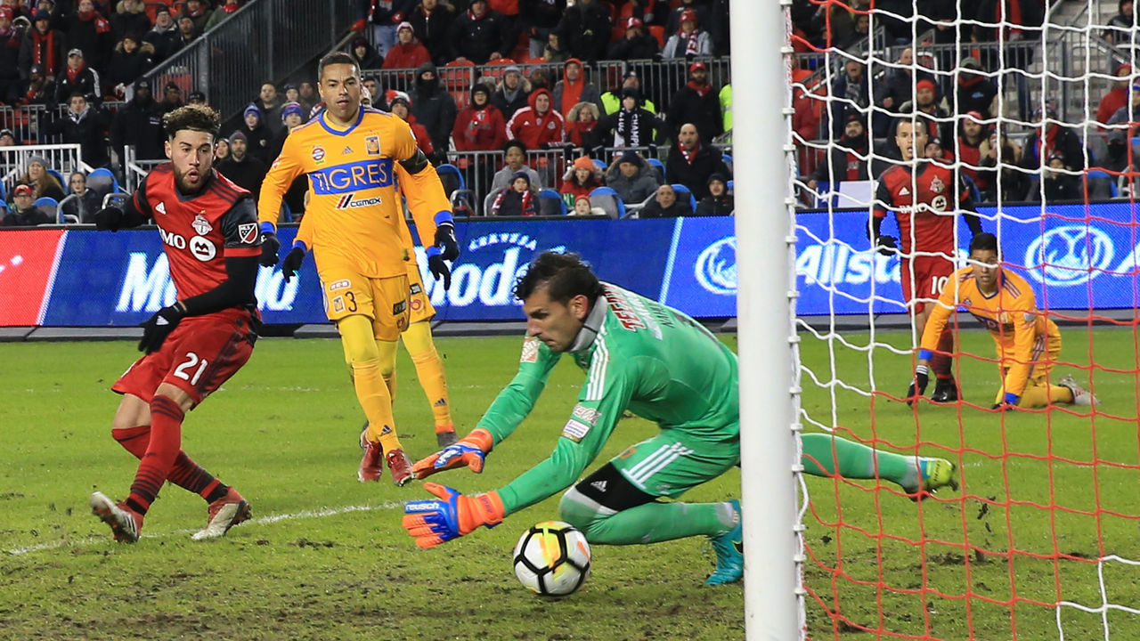 TORONTO , ON- MARCH 7 - CONCACAF CONCACAF TFC's Jonathan Osorio scores the winner and gets the ball past Club Tigres goal keeper Nahuel Guzman in the second half BMO in Toronto , March 7, 2018. (Rene Johnston/Toronto Star via Getty Images)