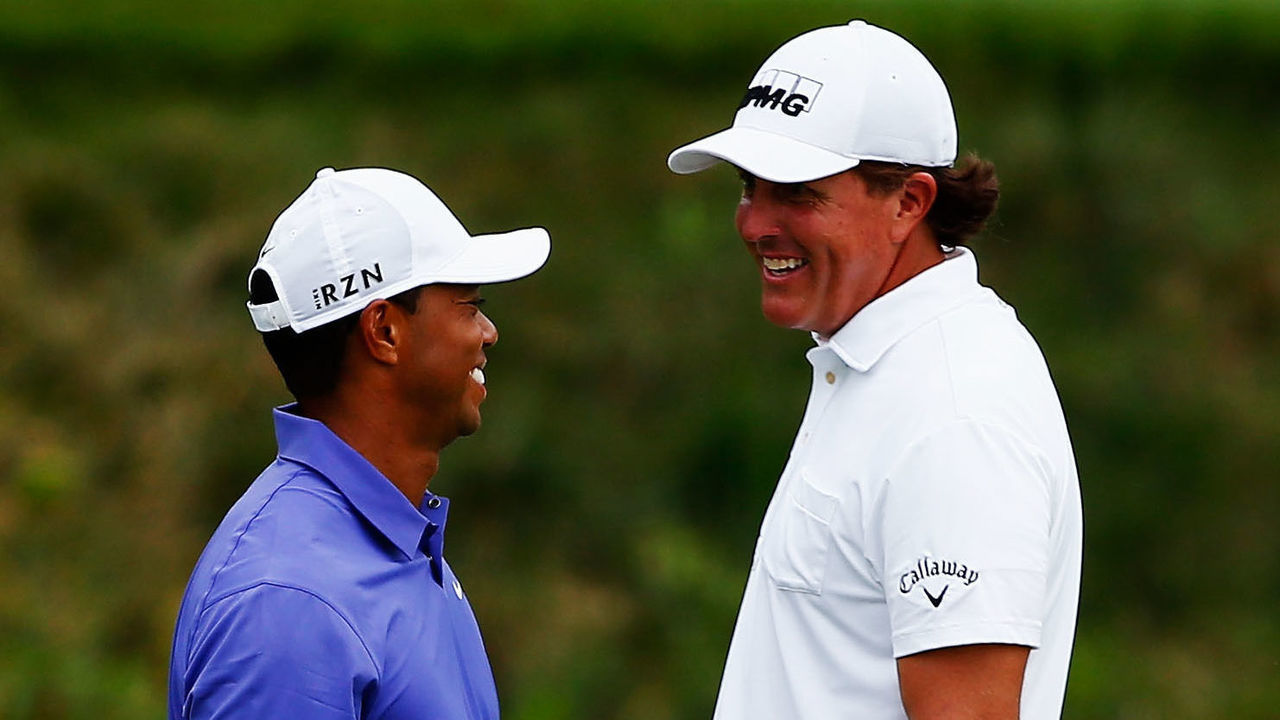 LOUISVILLE, KY - AUGUST 07: (L-R) Tiger Woods of the United States and Phil Mickelson of the United States laugh together on the 16th green during the first round of the 96th PGA Championship at Valhalla Golf Club on August 7, 2014 in Louisville, Kentucky.