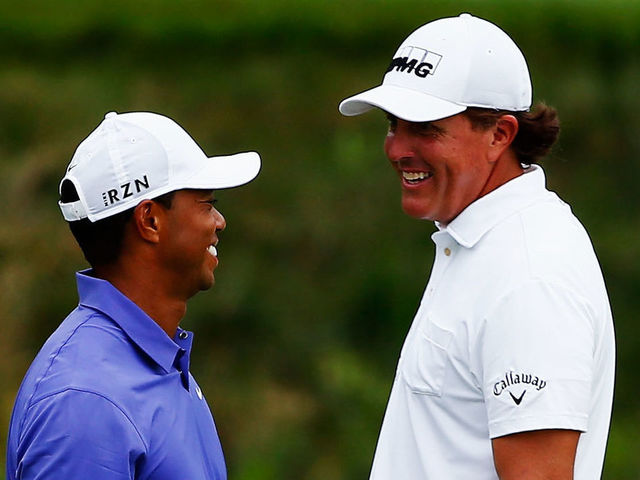 LOUISVILLE, KY - AUGUST 07: (L-R) Tiger Woods of the United States and Phil Mickelson of the United States laugh together on the 16th green during the first round of the 96th PGA Championship at Valhalla Golf Club on August 7, 2014 in Louisville, Kentucky.