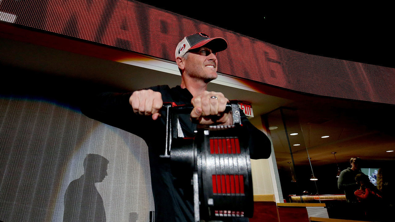 RALEIGH, NC - JANUARY 21: Tom Dundon, new owner of the Carolina Hurricanes, sounds the Hurricane warning siren calling players to the ice prior to an NHL game against the Vegas Golden Knights January 21, 2018 at PNC Arena in Raleigh, North Carolina.