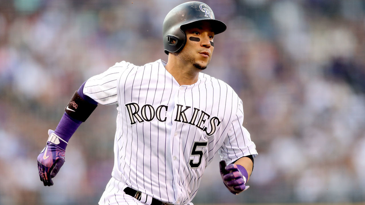 DENVER, CO - AUGUST 05: Carlos Gonzalez #5 of the Colorado Rockies scores on a Pat Valaika single in the first inning against the Philadelphia Phillies at Coors Field on August 5, 2017 in Denver, Colorado.