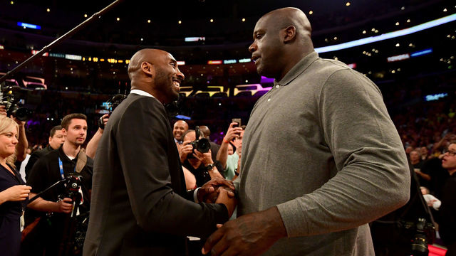 LOS ANGELES, CA - DECEMBER 18: Kobe Bryant and Shaquille O'Neal shake hands at halftime after both of Bryant's #8 and #24 Los Angeles Lakers jerseys are retired at Staples Center on December 18, 2017 in Los Angeles, California.