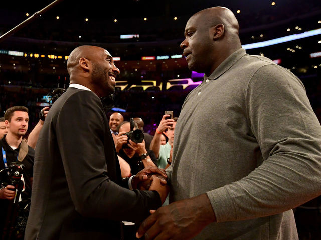 LOS ANGELES, CA - DECEMBER 18: Kobe Bryant and Shaquille O'Neal shake hands at halftime after both of Bryant's #8 and #24 Los Angeles Lakers jerseys are retired at Staples Center on December 18, 2017 in Los Angeles, California.