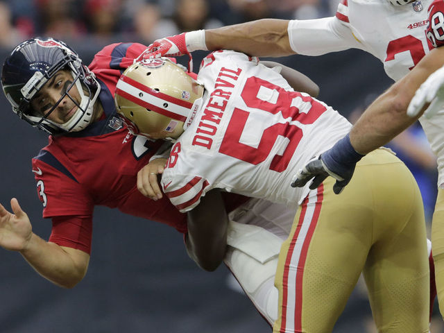 HOUSTON, TX - DECEMBER 10: Tom Savage #3 of the Houston Texans is hit by Elvis Dumervil #58 of the San Francisco 49ers in the second quarter at NRG Stadium on December 10, 2017 in Houston, Texas.