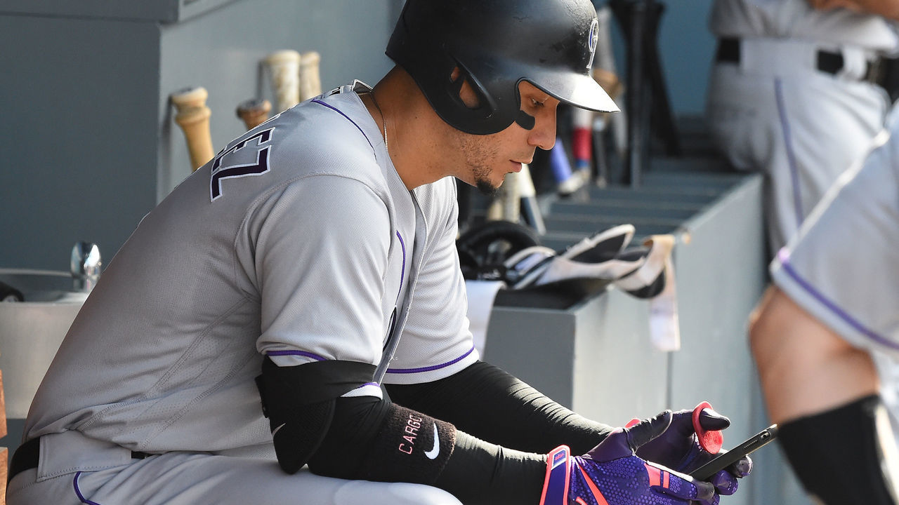 LOS ANGELES, CA - SEPTEMBER 10: Carlos Gonzalez #5 of the Colorado Rockies checks an iPad before going up to bat in the ninth inning of the game against the Los Angeles Dodgers at Dodger Stadium on September 10, 2017 in Los Angeles, California.