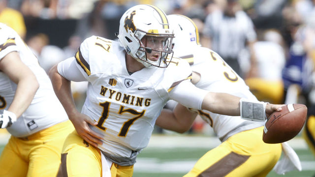 IOWA CITY, IOWA- SEPTEMBER 2: Quarterback Josh Allen #17 of the Wyoming Cowboys hands off the ball in the fourth quarter against the Iowa Hawkeyes, on September 2, 2017 at Kinnick Stadium in Iowa City, Iowa.