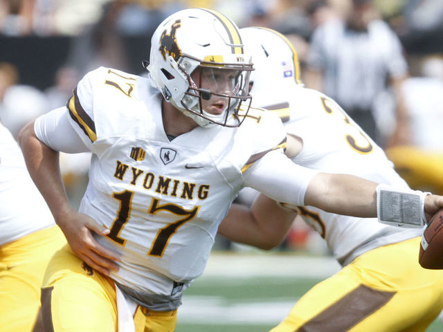 IOWA CITY, IOWA- SEPTEMBER 2: Quarterback Josh Allen #17 of the Wyoming Cowboys hands off the ball in the fourth quarter against the Iowa Hawkeyes, on September 2, 2017 at Kinnick Stadium in Iowa City, Iowa.