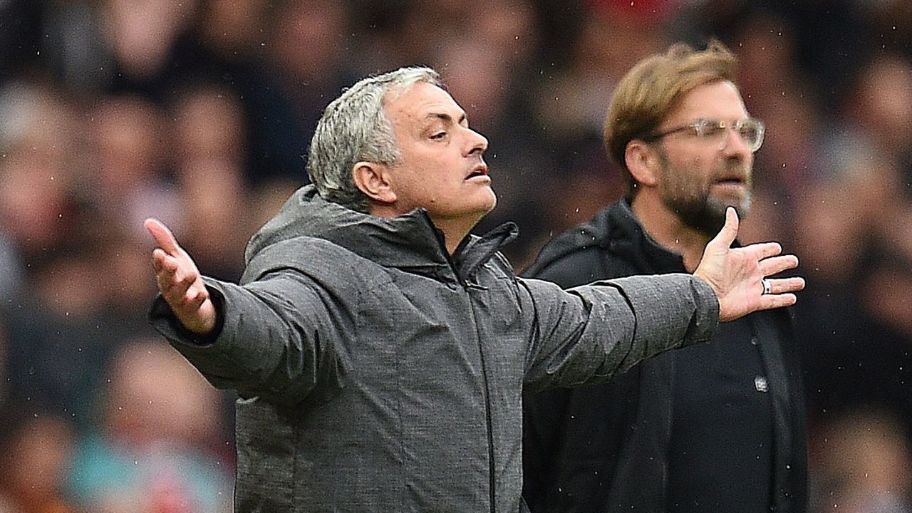 Manchester United's Portuguese manager Jose Mourinho (L) and Liverpool's German manager Jurgen Klopp (R) gesture on the touchline during the English Premier League football match between Manchester United and Liverpool at Old Trafford in Manchester, north west England, on March 10, 2018. / AFP PHOTO / Oli SCARFF /