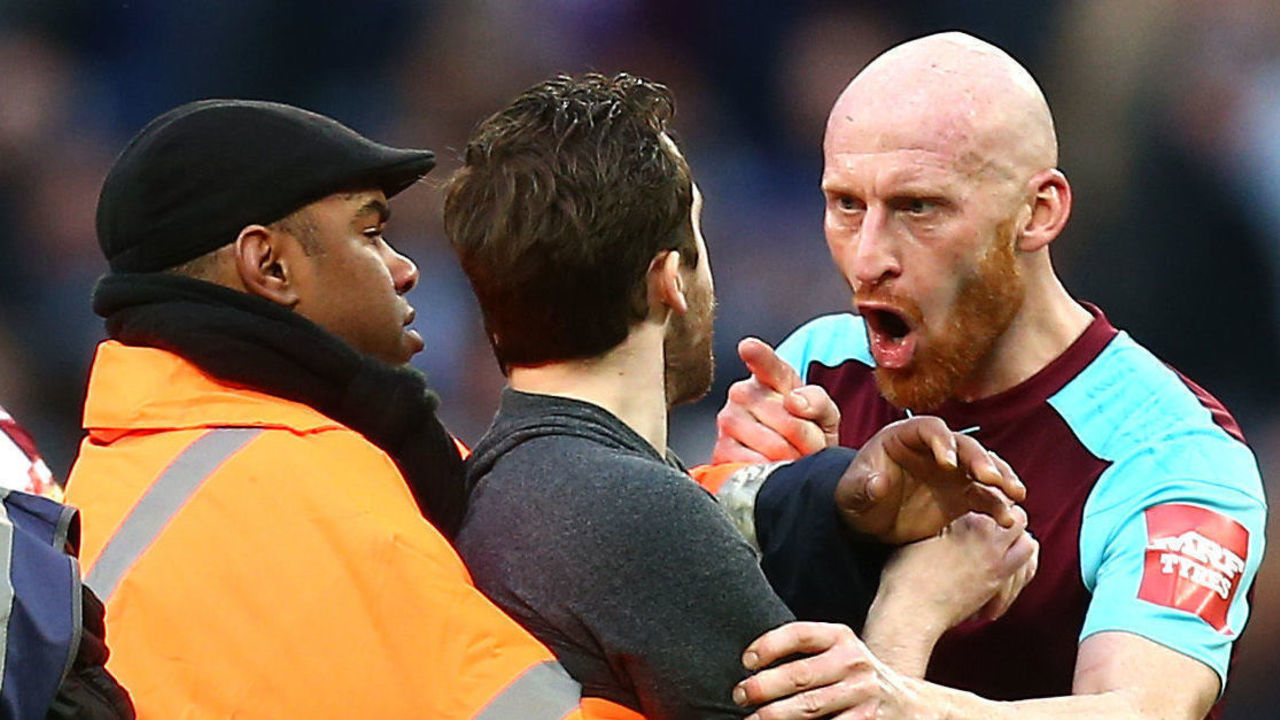 LONDON, ENGLAND - MARCH 10: James Collins of West Ham United confronts a pitch invader during the Premier League match between West Ham United and Burnley at London Stadium on March 10, 2018 in London, England.