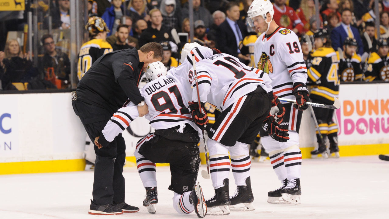 BOSTON, MA - MARCH 10: Anthony Duclair #91 of the Chicago Blackhawks gets helped off the ice after a play against the Boston Bruins at the TD Garden on March 10, 2018 in Boston, Massachusetts.