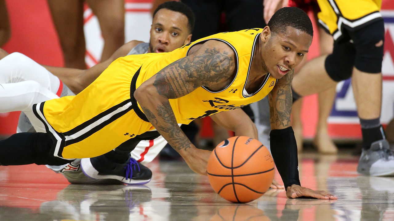 TUCSON, AZ - NOVEMBER 12: Jairus Lyles #10 of the UMBC Retrievers dives for a loose ball past Parker Jackson-Cartwright #0 of the Arizona Wildcats during the second half of the college basketball game at McKale Center on November 12, 2017 in Tucson, Arizona.