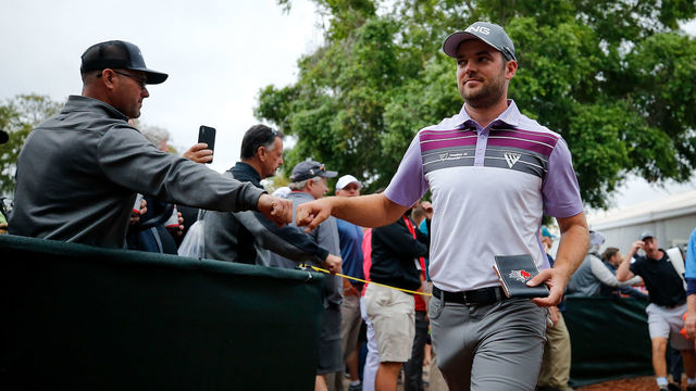 PALM HARBOR, FL - MARCH 10: Corey Conners of Canada fist bumps a fan after completeing his third round of the Valspar Championship at Innisbrook Resort Copperhead Course on March 10, 2018 in Palm Harbor, Florida.