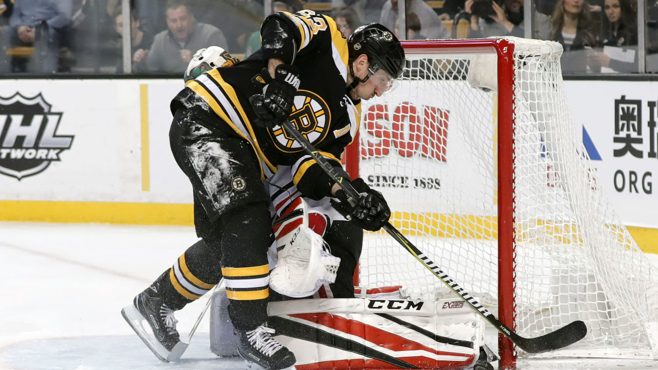 BOSTON, MA - MARCH 10: Chicago Blackhawks goalie Jean-Francois Berube (34) stops Boston Bruins left wing Brad Marchand (63) during a game between the Boston Bruins and the Chicago Blackhawks on March 10, 2018, at TD Garden in Boston, Massachusetts. The Bruins defeated the Blackhawks 7-4.