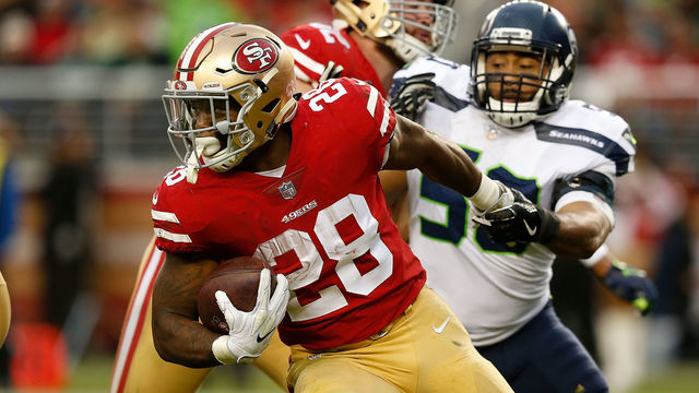 SANTA CLARA, CA - NOVEMBER 26: Carlos Hyde #28 of the San Francisco 49ers is tackled by K.J. Wright #50 of the Seattle Seahawks at Levi's Stadium on November 26, 2017 in Santa Clara, California.