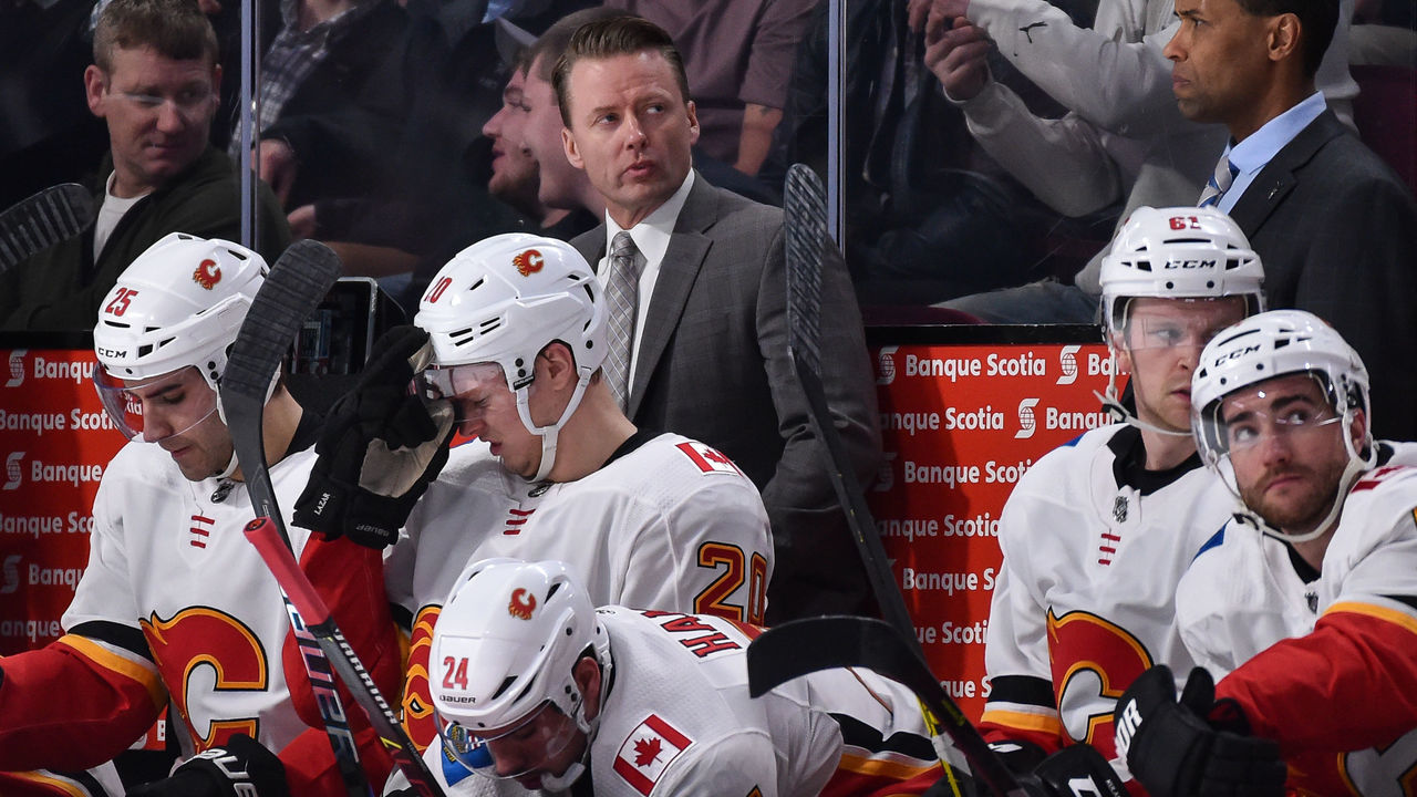 MONTREAL, QC - DECEMBER 07: Head coach of the Calgary Flames Glen Gulutzan looks on from behind the bench against the Montreal Canadiens during the NHL game at the Bell Centre on December 7, 2017 in Montreal, Quebec, Canada. The Calgary Flames defeated the Montreal Canadiens 3-2 in overtime.