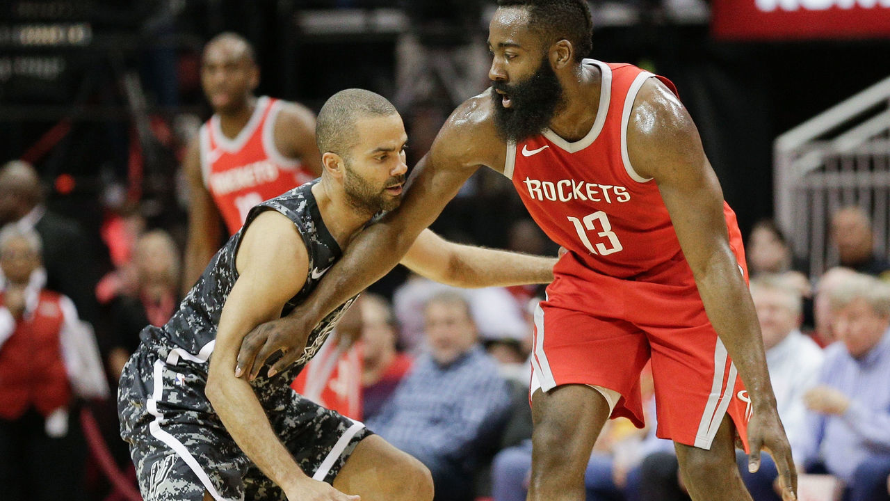 HOUSTON, TX - MARCH 12: James Harden #13 of the Houston Rockets holds off Tony Parker #9 of the San Antonio Spurs at Toyota Center on March 12, 2018 in Houston, Texas.