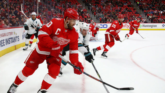 DETROIT, MI - JANUARY 31: Henrik Zetterberg #40 of the Detroit Red Wings battles with Joonas Donskoi #27 of the San Jose Sharks during the third period at Little Caesars Arena on January 31, 2018 in Detroit, Michigan. Detroit won the game 2-1 in a shootout.