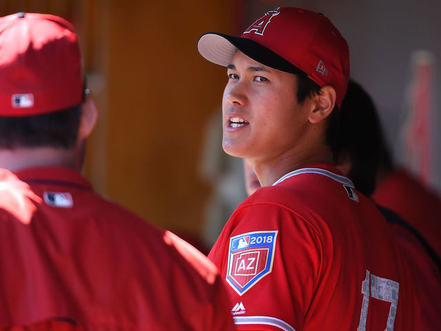 SCOTTSDALE, AZ - FEBRUARY 27: Shohei Ohtani #17 of the Los Angeles Angels of Anaheim talks with teammates in the dugout prior to the start of the first inning against the Colorado Rockies during a Spring Training game at Salt River Fields at Talking Stick on February 27, 2018 in Scottsdale, Arizona.