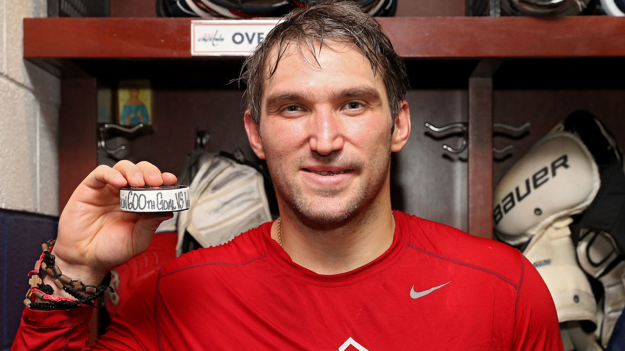 WASHINGTON, DC - MARCH 12: Alex Ovechkin #8 of the Washington Capitals poses with the puck commemorating his 600th career goal which he scored during the second period against the Winnipeg Jets at Capital One Arena on March 12, 2018 in Washington, DC.