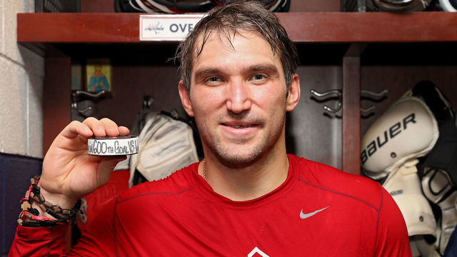 WASHINGTON, DC - MARCH 12: Alex Ovechkin #8 of the Washington Capitals poses with the puck commemorating his 600th career goal which he scored during the second period against the Winnipeg Jets at Capital One Arena on March 12, 2018 in Washington, DC.
