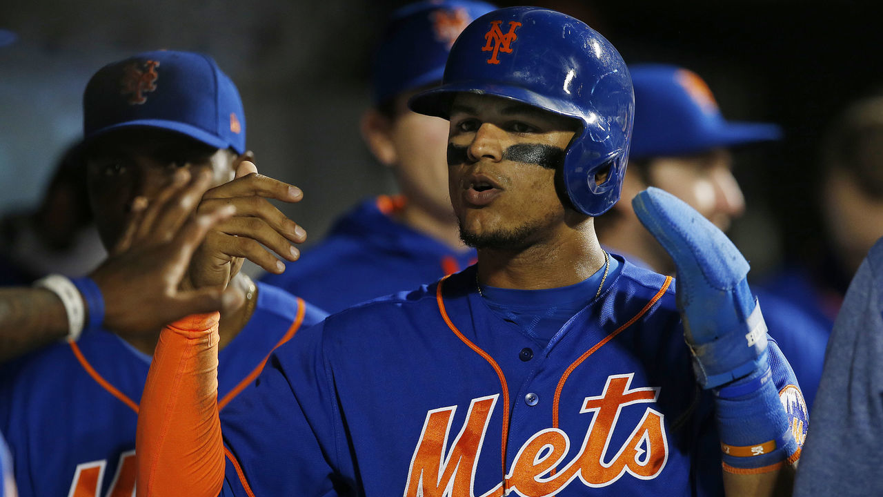 NEW YORK, NY - SEPTEMBER 25: Juan Lagares #12 of the New York Mets is congratulated after scoring on a double by Travis d'Arnaud #18 in the third inning against the Atlanta Braves during the second game of a doubleheader at Citi Field on September 25, 2017 in the Flushing neighborhood of the Queens borough of New York City.