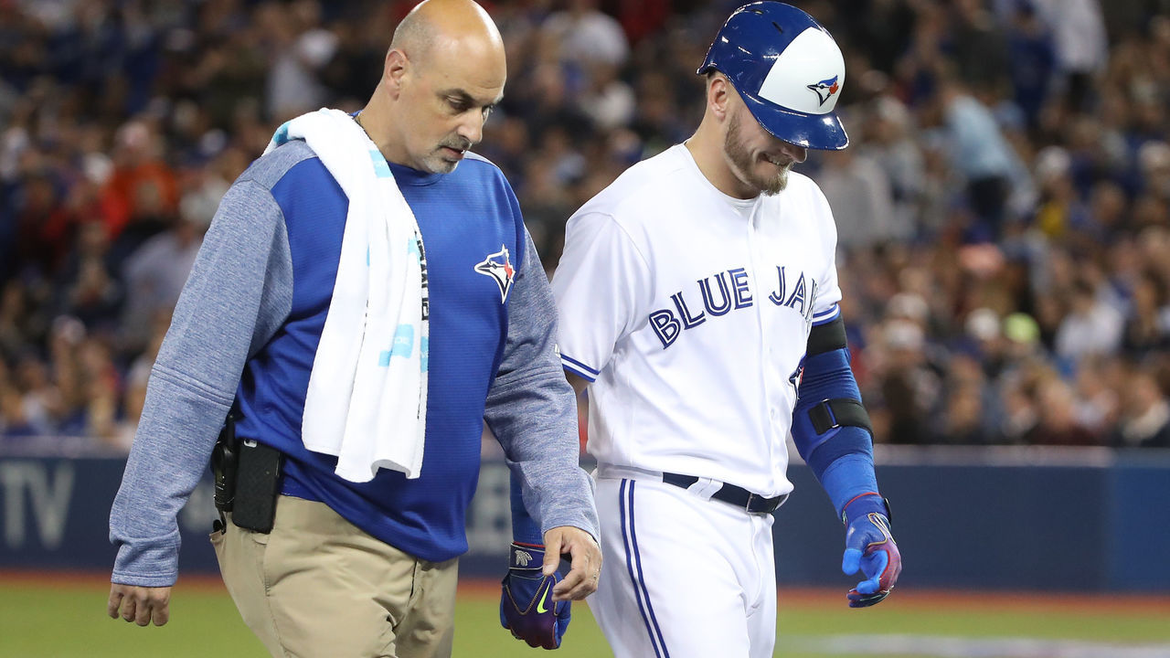 TORONTO, ON - APRIL 13: Josh Donaldson #20 of the Toronto Blue Jays exits the game with trainer George Poulos after hitting an RBI double in the sixth inning during MLB game action against the Baltimore Orioles at Rogers Centre on April 13, 2017 in Toronto, Canada.