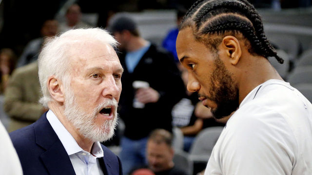 SAN ANTONIO,TX - DECEMBER 18 : Kawhi Leonard #2 of the San Antonio Spurs chats with head coach Gregg Popovich before the start of their game against the Los Angeles Clippers at AT&T Center on December 18, 2017 in San Antonio, Texas. NOTE TO USER: User expressly acknowledges and agrees that , by downloading and or using this photograph, User is consenting to the terms and conditions of the Getty Images License Agreement.