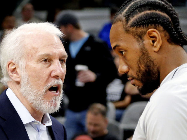 SAN ANTONIO,TX - DECEMBER 18 : Kawhi Leonard #2 of the San Antonio Spurs chats with head coach Gregg Popovich before the start of their game against the Los Angeles Clippers at AT&T Center on December 18, 2017 in San Antonio, Texas. NOTE TO USER: User expressly acknowledges and agrees that , by downloading and or using this photograph, User is consenting to the terms and conditions of the Getty Images License Agreement.