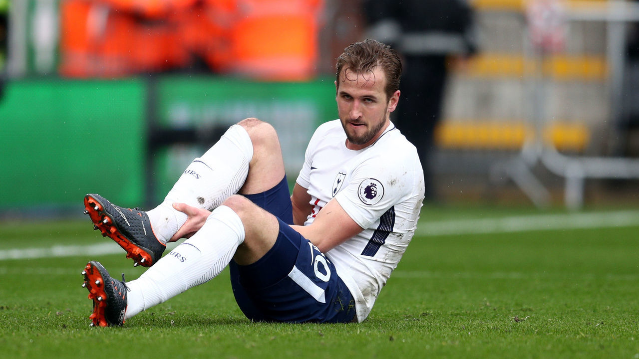 BOURNEMOUTH, ENGLAND - MARCH 11: An injured Harry Kane of Tottenham Hotspur holds his ankle during the Premier League match between AFC Bournemouth and Tottenham Hotspur at Vitality Stadium on March 10, 2018 in Bournemouth, England.
