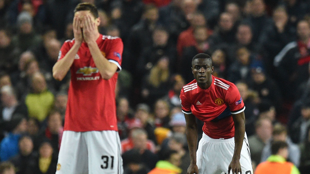 TOPSHOT - Manchester United's Serbian midfielder Nemanja Matic (L) and Manchester United's Ivorian defender Eric Bailly react after Sevilla scored their second goal during a last 16 second leg UEFA Champions League football match between Manchester United and Sevilla at Old Trafford in Manchester, northwest England on March 13, 2018. / AFP PHOTO / Oli SCARFF