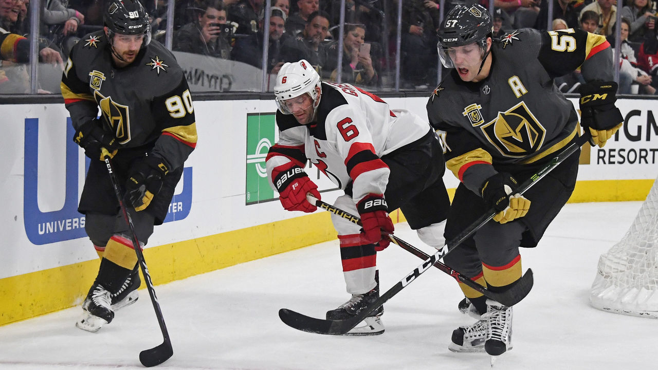 LAS VEGAS, NV - MARCH 14: Tomas Tatar #90 of the Vegas Golden Knights, Andy Greene #6 of the New Jersey Devils and David Perron #57 of the Golden Knights chase the puck in the second period of their game at T-Mobile Arena on March 14, 2018 in Las Vegas, Nevada.