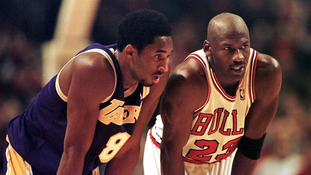CHICAGO, UNITED STATES: Los Angeles Lakers guard Kobe Bryant(L) and Chicago Bulls guard Michael Jordan(R) talk during a free-throw attempt during the fourth quarter 17 December at the United Center in Chicago. Bryant, who is 19 and bypassed college basketball to play in the NBA, scored a team-high 33 points off the bench, and Jordan scored a team-high 36 points. The Bulls defeated the Lakers 104-83. AFP PHOTO VINCENT LAFORET