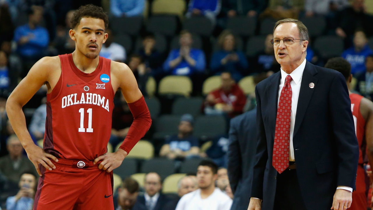 PITTSBURGH, PA - MARCH 15: Head coach Lon Kruger of the Oklahoma Sooners (R) speaks to Trae Young #11 in the first half of the game against the Rhode Island Rams during the first round of the 2018 NCAA Men's Basketball Tournament at PPG PAINTS Arena on March 15, 2018 in Pittsburgh, Pennsylvania.