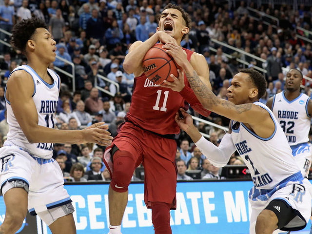 PITTSBURGH, PA - MARCH 15: Trae Young #11 of the Oklahoma Sooners reacts between Jeff Dowtin #11 and Fatts Russell #2 of the Rhode Island Rams in the second half of the game during the first round of the 2018 NCAA Men's Basketball Tournament at PPG PAINTS Arena on March 15, 2018 in Pittsburgh, Pennsylvania.