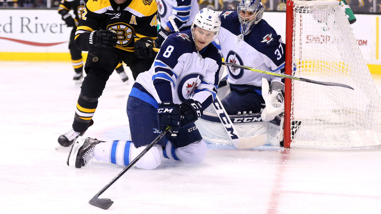 BOSTON, MA - DECEMBER 21: Jacob Trouba #8 of the Winnipeg Jets shields the puck from David Backes #42 of the Boston Bruins during the first period at TD Garden on December 21, 2017 in Boston, Massachusetts.