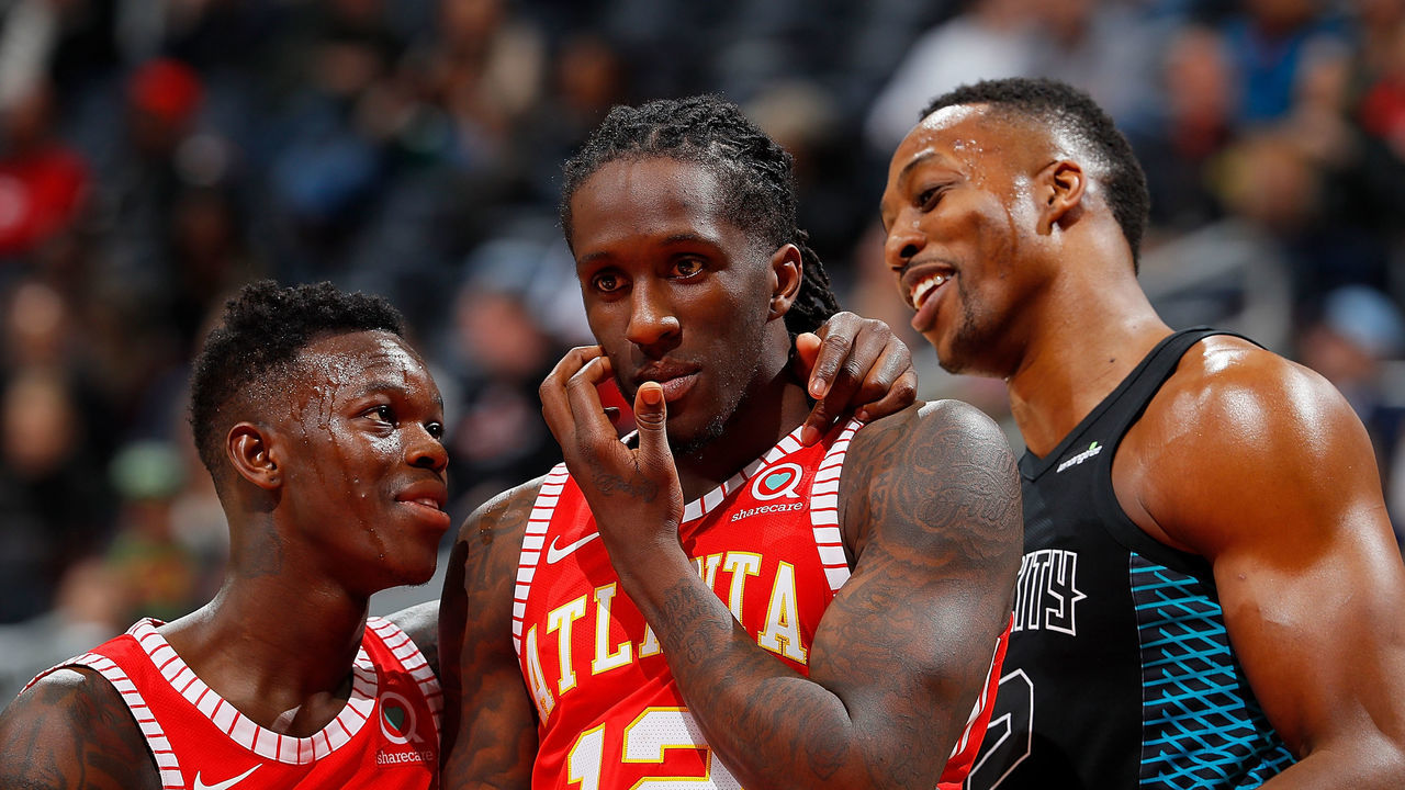 ATLANTA, GA - JANUARY 31: Dennis Schroder #17 and Taurean Prince #12 of the Atlanta Hawks converse next to Dwight Howard #12 of the Charlotte Hornets during the game at Philips Arena on January 31, 2018 in Atlanta, Georgia.