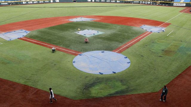 Workers prepare the field at the Charros of Jalisco stadium on February 1, 2018, the day before the start of the Caribbean Baseball Series in Guadalajara, Jalisco state, Mexico. Teams representing the Dominican Republic, Puerto Rico, Cuba, Venezuela and Mexico participate in the tournament that takes place from February 2 to 8. / AFP PHOTO / ULISES RUIZ