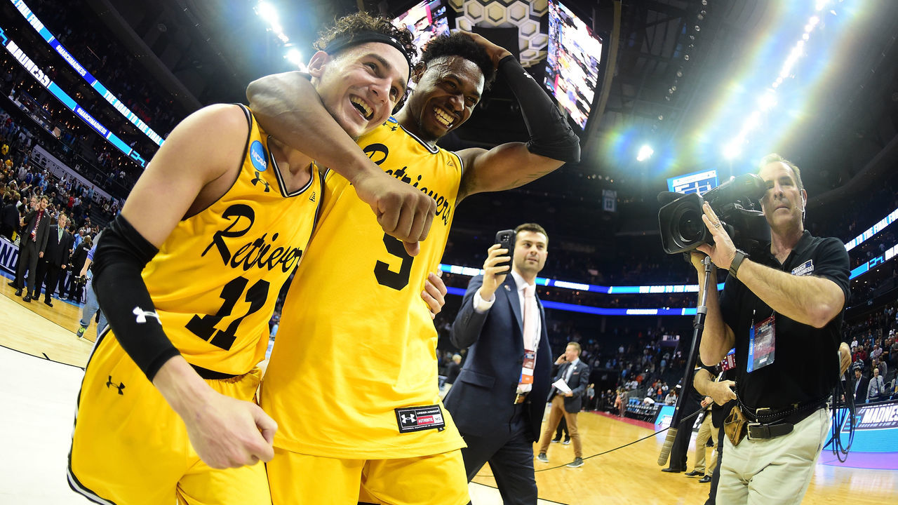 CHARLOTTE, NC - MARCH 16: K.J. Maura #11 and teammate Jourdan Grant #5 of the UMBC Retrievers celebrate their 74-54 victory over the Virginia Cavaliers during the first round of the 2018 NCAA Men's Basketball Tournament at Spectrum Center on March 16, 2018 in Charlotte, North Carolina.